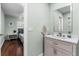 Bathroom with a modern vanity, mirror and view into the connected bedroom at 328 Lake Fair Ln, Winter Park, FL 32789