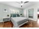 Bedroom featuring hardwood floors, modern decor, and a large window with shutters at 328 Lake Fair Ln, Winter Park, FL 32789