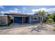 Blue house featuring a covered carport with concrete flooring at 328 Lake Fair Ln, Winter Park, FL 32789