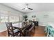 Dining room featuring a dark wood table, bench seating, and natural light from the window at 328 Lake Fair Ln, Winter Park, FL 32789