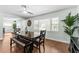 Bright dining room with a dark wood table, bench seating, and views through large windows at 328 Lake Fair Ln, Winter Park, FL 32789