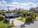 Beautiful single-story home with a lush, landscaped front yard and a boat on the drive at 328 Lake Fair Ln, Winter Park, FL 32789