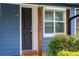 A close-up of the home's front door, featuring a dark finish and wood post accents at 328 Lake Fair Ln, Winter Park, FL 32789