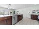 Renovated kitchen featuring stainless steel appliances, dark wood cabinets, and tiled flooring at 328 Lake Fair Ln, Winter Park, FL 32789