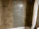 Updated bathroom featuring a mosaic tile strip running vertically through the shower at 335 Wymore Rd # 201, Altamonte Springs, FL 32714