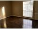 Bedroom features a large window with window shade and laminate wood floors at 335 Wymore Rd # 201, Altamonte Springs, FL 32714