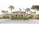 Inviting community clubhouse featuring lush landscaping, palm trees and decorative entrance way at 335 Wymore Rd # 201, Altamonte Springs, FL 32714