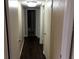 Hallway features dark laminate wood floors and white doors throughout at 335 Wymore Rd # 201, Altamonte Springs, FL 32714