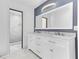Modern bathroom with double vanity, sleek mirrors, and glass-enclosed shower with marble tiles at 3547 Medford Rd, Casselberry, FL 32707