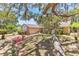 Exterior of a tan home with stone facade surrounded by mature trees, landscaping and blue skies at 3547 Medford Rd, Casselberry, FL 32707