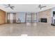 A spacious living room with a fireplace, tiled floors, and glass sliding doors, creating an inviting atmosphere at 3547 Medford Rd, Casselberry, FL 32707