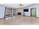 Open concept living room features a stone fireplace, fan, and sliding glass doors for natural light at 3547 Medford Rd, Casselberry, FL 32707
