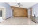 Living room featuring tile floors, neutral paint, ceiling fan, and a decorative wall at 3547 Medford Rd, Casselberry, FL 32707