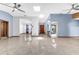 Open-concept living area with tile floors leads to the kitchen and dining room, with modern ceiling fans at 3547 Medford Rd, Casselberry, FL 32707