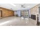 Spacious living room with a cozy fireplace, ceiling fans, and sliding doors to the outside at 3547 Medford Rd, Casselberry, FL 32707