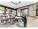 Bright sunroom featuring a unique skylight and shelving, perfect for potting plants and soaking up the sun at 3547 Medford Rd, Casselberry, FL 32707