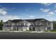 A row of townhouses featuring a simple design, each with a private garage and well-kept lawn in front at 399 Sequoia Dr, Lake Wales, FL 33859