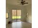 Bright living room with hardwood flooring, a ceiling fan, and access to the backyard at 415 Cinnamon Dr, Kissimmee, FL 34759