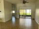 Open living room with tile flooring, a ceiling fan, and sliding glass doors to the backyard at 415 Cinnamon Dr, Kissimmee, FL 34759