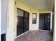 A screened in patio with neutral tile flooring features an outdoor living space at 415 Cinnamon Dr, Kissimmee, FL 34759