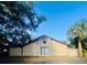 Architectural home showcasing stucco siding, a red tile roof, and large arched window design at 426 Club Dr, Winter Springs, FL 32708