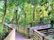 Scenic wooden walking path winding through lush greenery and mature trees at 426 Club Dr, Winter Springs, FL 32708