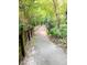 Concrete walking path surrounded by lush greenery and trees at 426 Club Dr, Winter Springs, FL 32708