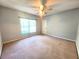 Comfortable bedroom showcasing a window, neutral walls, carpet flooring, and ceiling fan at 4331 Willowcrest Ct, Orlando, FL 32826