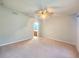 Spacious bedroom featuring neutral walls, plush carpeting, and a ceiling fan at 4331 Willowcrest Ct, Orlando, FL 32826