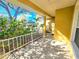 View of a sunny covered front porch lined with a white railing and green foliage at 4331 Willowcrest Ct, Orlando, FL 32826