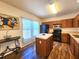 Well-lit kitchen features wood cabinets, a center island, and black appliances at 4331 Willowcrest Ct, Orlando, FL 32826