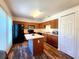 Well-lit kitchen features wood cabinets, a center island, and black appliances at 4331 Willowcrest Ct, Orlando, FL 32826