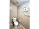 The powder room features a standard toilet, tiled floors, and decor at 4331 Willowcrest Ct, Orlando, FL 32826