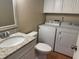 Bathroom with granite countertop vanity, white cabinets, toilet, and laundry area at 5286 Willow Ct # 505, Orlando, FL 32811