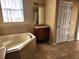 Bathroom featuring tile flooring, a bathtub, and a vanity with sink and drawers at 602 Lochsmere Ln, Orlando, FL 32828