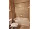 Bathroom featuring a tiled shower-tub combo and a white toilet at 602 Lochsmere Ln, Orlando, FL 32828