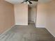 Neutral-colored bedroom featuring carpet flooring, ceiling fan, and doorway leading to other rooms at 602 Lochsmere Ln, Orlando, FL 32828