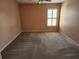 Bedroom with neutral carpet, peach walls, a ceiling fan, and a window with white blinds at 602 Lochsmere Ln, Orlando, FL 32828