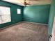 Bedroom with teal walls, carpet flooring, a ceiling fan, and a window with blinds at 602 Lochsmere Ln, Orlando, FL 32828