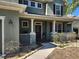 Charming front porch with white columns, decorative railing, and a landscaped walkway at 602 Lochsmere Ln, Orlando, FL 32828