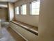 Hallway featuring a built-in cushioned bench under three windows providing natural light at 602 Lochsmere Ln, Orlando, FL 32828