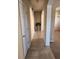 Hallway with tile flooring, arched openings, and a decorative plant at 602 Lochsmere Ln, Orlando, FL 32828