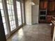 Eat-in kitchen area featuring tile floors, double doors to lanai, and modern appliances at 602 Lochsmere Ln, Orlando, FL 32828