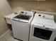 Bright laundry room featuring a washing machine, dryer, and a utility sink at 602 Lochsmere Ln, Orlando, FL 32828