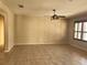 Spacious living room featuring tile floors, a ceiling fan, neutral walls, and shuttered windows at 602 Lochsmere Ln, Orlando, FL 32828