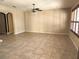 Living room features tile floors, a ceiling fan, neutral walls, and shuttered windows at 602 Lochsmere Ln, Orlando, FL 32828