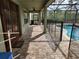 Paver patio with a screened-in pool and fencing at 602 Lochsmere Ln, Orlando, FL 32828