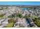 Overhead shot of community featuring townhomes near a serene lake, showcasing the property's tranquil setting at 606 Casa Park I Court, Winter Springs, FL 32708