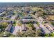 Aerial view of townhome community, highlighting lush landscaping, serene ponds, and convenient parking at 606 Casa Park I Court, Winter Springs, FL 32708