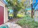 Landscaped backyard with lush greenery and patio at 606 Casa Park I Court, Winter Springs, FL 32708